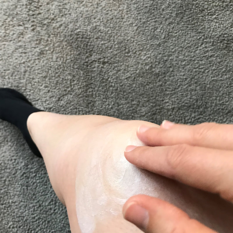 Rubbing Kunzea 'extra strength' lotion into knee